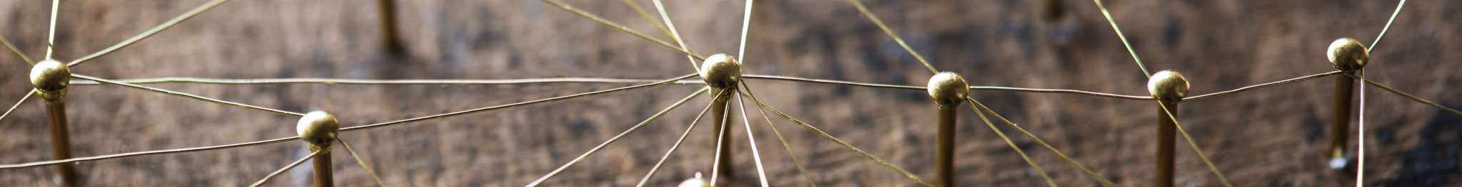 Close-up of a map with twine-connected pins