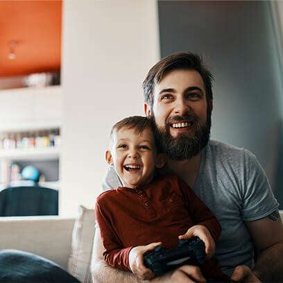 Family on couch with game controller