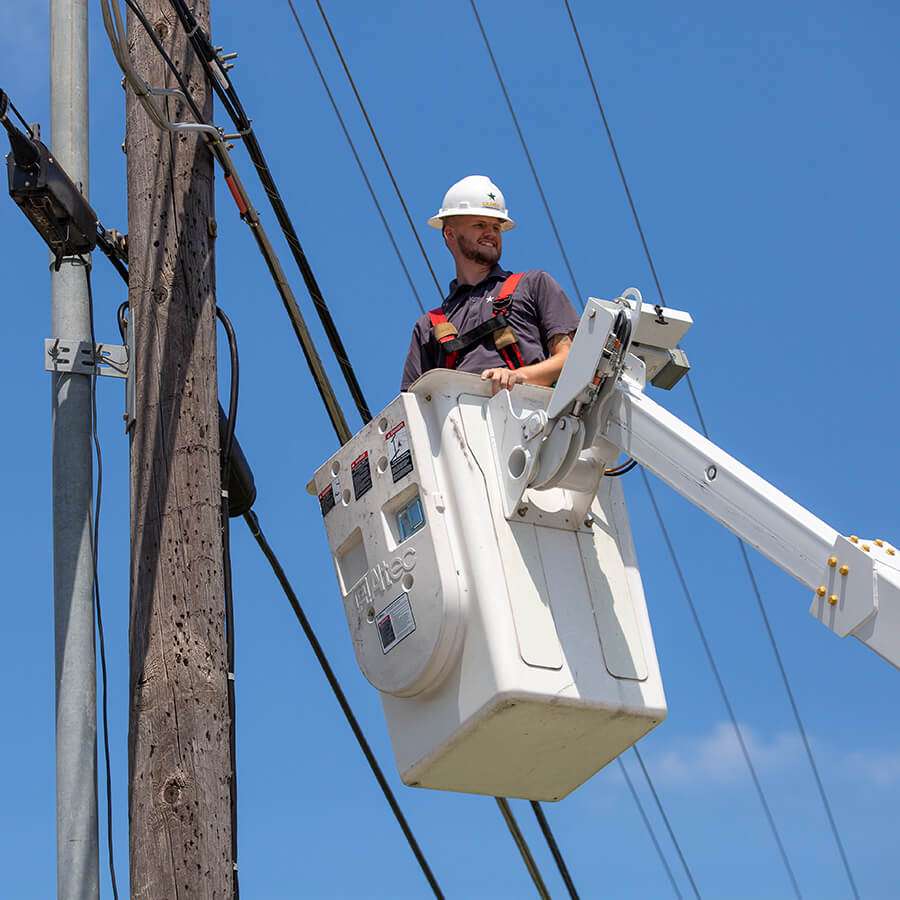 man high up in the wires