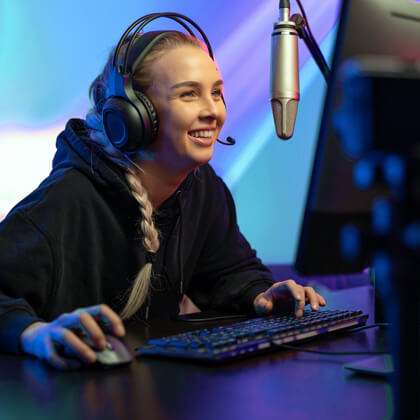 Young woman at her computer with full PC gamer setup