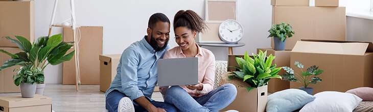 Couple sets up laptop while moving