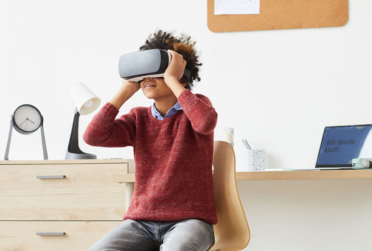 middle school boy playing with VR